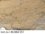 Sandstone is a fragmentary sedimentary rock, a homogeneous or layered aggregate of fragmentary grains and grains of sand bound by any mineral substance, cement. Quarry natural yellow sand wall. Стоковое фото, фотограф Юлия Петровская / Фотобанк Лори