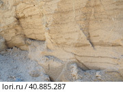 Sandstone is a fragmentary sedimentary rock, a homogeneous or layered aggregate of fragmentary grains and grains of sand bound by any mineral substance, cement. Quarry natural yellow sand wall. Стоковое фото, фотограф Юлия Петровская / Фотобанк Лори