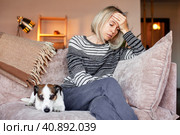 Tired upset woman worried about tiredness from domestic work sitting at couch. Стоковое фото, фотограф Гладских Татьяна / Фотобанк Лори