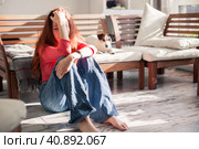 Sad depressed young adult woman crying alone at home, upset. Стоковое фото, фотограф Гладских Татьяна / Фотобанк Лори