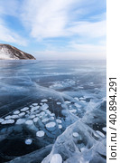 Scenic winter landscape of frozen Baikal Lake in cold winter day. Natural seasonal background with blue ice cover with white bubbles and cracks.  Winter ice travel and active outdoors. Стоковое фото, фотограф Виктория Катьянова / Фотобанк Лори