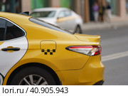 Photography of city taxi on the motorway in summer day. Image with defocused background. Suitable for posters, greeting card. Close up image. Стоковое фото, фотограф YuryKara / Фотобанк Лори