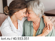 Older mature mother and grown millennial daughter laughing embracing, caring smiling young woman embracing happy senior middle aged mom. Стоковое фото, фотограф Гладских Татьяна / Фотобанк Лори