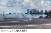 Passing a turn in a drift drift by cars. Slow motion. Races at the Moscow Grand Prix Drift at the motorsport stadium in Kuryanovo. Russia. Moscow. 30.07.2023. Редакционное видео, видеограф Ярославский Максим / Фотобанк Лори
