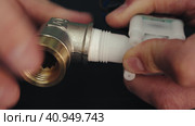 Sealing and Fixing: Applying Thread Seal Tape and Sealant to Plumbing Fitting. Стоковое видео, видеограф Dzmitry Astapkovich / Фотобанк Лори