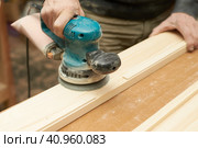 A man treats a wooden product with a grinding machine. Стоковое фото, фотограф Стас Пересыпкин / Фотобанк Лори