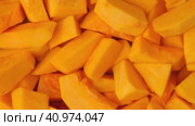 Slices of fresh pumpkin chunks background. Yellow Juicy pieces of pumpkin. Texture close up. Turning, rotation. Full frame with copy space for text, label. Food backdrop. Bright orange sliced pumpkin. Стоковое видео, видеограф Марина Демидюк / Фотобанк Лори