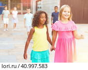Two young girls walking hand in hand. Стоковое фото, фотограф Яков Филимонов / Фотобанк Лори
