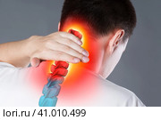 Pain in the spine, a man with backache, injury in the human neck, chiropractic treatments concept. Стоковое фото, фотограф Станислав Тарко / Фотобанк Лори