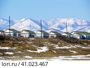 Many identical houses for camping and basing at the foot of the snowy mountains. Far East, Russia. Стоковое фото, фотограф Татьяна Терехина / Фотобанк Лори