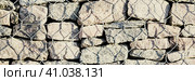 Wall of stones held by a metal mesh. Wide panoramic texture for background and design. Стоковое фото, фотограф Андрей Степанов / Фотобанк Лори