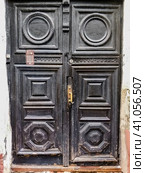 Ancient wooden black doors with infill and door handle. Стоковое фото, фотограф Константин Григорьев / Фотобанк Лори