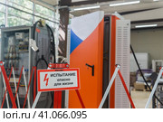 Табличка с надписью Испытание! Опасно для жизни! на ограждении на фоне размытого электрооборудования в цехе. Стоковое фото, фотограф Евгений Харитонов / Фотобанк Лори