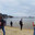 People rest on the sandy shore of the Black Sea next to white swans (2023 год). Редакционное видео, видеограф Станислав Типляшин / Фотобанк Лори