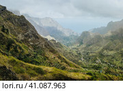 Gorgeous panorama view of a fertile Paul valley. Agriculture terraces in vertical valley sides, rugged peaks and motion clouds on horizon. Стоковое фото, фотограф Igor Tichonow / Фотобанк Лори