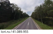 The drone's camera is flying over the road at high speed in the countryside. Summer trip. Стоковое видео, видеограф Ярославский Максим / Фотобанк Лори