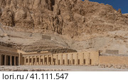 Fragment of the funerary temple of the queen -Pharaoh Hatshepsut. Colonnade and halls carved into a sheer cliff. Blue sky. Egypt. Luxor (2021 год). Стоковое фото, фотограф Вера Ивановна Кубарева / Фотобанк Лори