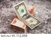 Dollar usa on stack of banknotes 5000 ruble notes on stone texture table, one million cash money. Five thousand russian rubles and dollar, bills backgrounds. Exchange currency concept. Copy text space. Стоковое фото, фотограф Aleksandr Golubev / Фотобанк Лори