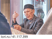 Mullah talking gesturing with his hands at rural house. Стоковое фото, фотограф Ирина Кононова / Фотобанк Лори