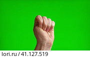 Female Hand with Beige Manicure making Rise Up Sign Symbol with her Fist. Chroma key Green Screen Background. Gestures Movements. Body Language. 4K Footage. Close Up. Raised hand with clenched fist. Стоковое видео, видеограф Марина Демидюк / Фотобанк Лори