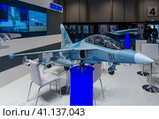 BERLIN, GERMANY - JUNE 01, 2016: The stand of Unated Aircraft Corporation (Russia). Model of Russian subsonic two-seat advanced jet trainer Yakovlev Yak-130. Exhibition ILA Berlin Air Show 2016. Редакционное фото, фотограф Sergey Kohl / Фотобанк Лори