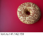 A doughnut or donut. A type of leavened fried dough. Sweet snack. Delicious pie with light icing on gray background. Стоковое фото, фотограф Юлия Петровская / Фотобанк Лори