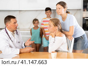Family physician consults girl child with sore throat from large family at home. Стоковое фото, фотограф Яков Филимонов / Фотобанк Лори