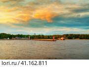 View from Lake Ladoga on the pier of Konevets Island. In the distance are the domes of the Konevets Nativity of the Virgin Mother of God Monastery. Стоковое фото, фотограф Оксана Медведева / Фотобанк Лори