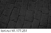 Graphic drawing of paving stones in an ancient square in the old city. Gray background with black pattern. Стоковая иллюстрация, иллюстратор Юлия Петровская / Фотобанк Лори