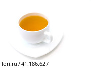 White porcelain cup with freshly brewed green tea isolated on white background. Selective focus. Белая фарфоровая чашка со свежезаваренным зеленым чаем, выделенная на белом фоне. Избирательный фокус. Стоковое фото, фотограф Дмитрий Березнев / Фотобанк Лори
