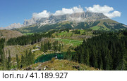 Adult women on the top of hill with view of uprooted pine trees after strong wind in Lake Carezza - Стоковое фото, фотограф Igor Tichonow / Фотобанк Лори