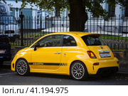 Fiat 500 Abarth parked in the street. Yellow small popular city car. Редакционное фото, фотограф Константин Григорьев / Фотобанк Лори