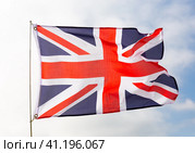 Flag of united kingdom flying with pride with blue sky as background. Стоковое фото, фотограф Яков Филимонов / Фотобанк Лори