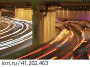 Long exposure photography. Defocused photography of Moscow cityscape in night time. Big traffic. Street is filled by cars. Blurred motion of cars at motorway. Frontal and back / rear view. Стоковое фото, фотограф YuryKara / Фотобанк Лори