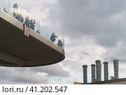Moscow, Russia - October 5, 2019: Photography of HES-1 named after Smidovich (State Power Station No. 1) - the oldest operating thermal power station in Russia. Raushskaya embankment, part of Mosenergo. Observation Deck Zaryadye Park at autumn day. International touristic concepts. Редакционное фото, фотограф YuryKara / Фотобанк Лори