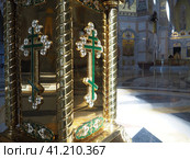 Lectern is portable piece of furniture used in celebrations of the Christian church. A close-up image of a gold cross on the side of the icon stand. Pulpits also called lecterns, rostrums and podiums. Стоковое фото, фотограф Юлия Петровская / Фотобанк Лори