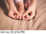Woman's leg hurts, pain in the foot, massage of female feet. Стоковое фото, фотограф Станислав Тарко / Фотобанк Лори