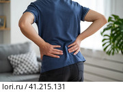 Back pain, kidney inflammation, man suffering from backache at home. Стоковое фото, фотограф Станислав Тарко / Фотобанк Лори
