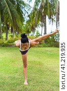 Compass pose variation or Surya Yantrasana yoga with ukrainian woman making it outdoors. Стоковое фото, фотограф Татьяна Терехина / Фотобанк Лори
