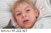 5 years Boy joking, sticking tongue out with silly expression. Child making face. Funny foolishness portrait of little boy in white bedroom. Adorable caucasian kid making crazy and comical gesture. Стоковое видео, видеограф Марина Демидюк / Фотобанк Лори