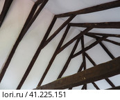 Fachwerk, a frame construction typical of the peasant architecture of many countries of Europe. Prussian wall. The roof truss system of the house. Ceiling beams, rafters and gratings. Стоковое фото, фотограф Юлия Петровская / Фотобанк Лори