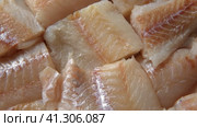 Raw fish fillet is spinning. Top view. Slices of fresh whitefish. Full frame. Sashimi rotation. Close up. Marine market. Video for sale. Cod, pollock loin steaks. Pangasius, tilapia pieces background. Стоковое видео, видеограф Марина Демидюк / Фотобанк Лори