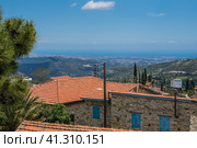 Picturesque photo of a valley on Cyprus. View to the Mediterranean Sea from the hill where the village Lefkara is. Cozy houses with red tiled roof and blue shuttered window on the front. Живописная фотография долины на Кипре. Вид на Средиземное море с холма, на котором находится деревня Лефкара. Уютные домики с красной черепичной крышей и голубыми ставнями на окнах спереди (2019 год). Стоковое фото, фотограф Дмитрий Березнев / Фотобанк Лори
