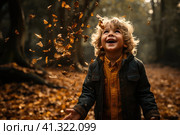 Little boy having fun during stroll in the forest at sunny autumn day. Child playing maple leaves. Baby tossing the leaves up. Active family time on nature. Hiking with little kids. Dry leaves rustle. Стоковое AI-изображение, AI-художник Ирина Михайличенко / Фотобанк Лори