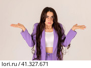 No idea. Unaware careless young beautiful caucasian confused woman wearing fashionable business outfit with open arms, no idea and doubtful face. I don't know concept. Стоковое фото, фотограф Ирина Михайличенко / Фотобанк Лори