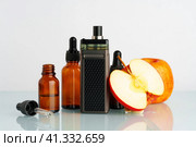 Vape liquid with apple flavor on white background. Стоковое фото, фотограф Сергей Толмачёв / Фотобанк Лори