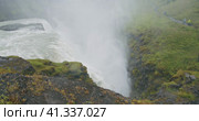 Cliff and falling water from the edge of Gullfoss waterfall in Iceland located in the Golden circle. Стоковое видео, видеограф Igor Tichonow / Фотобанк Лори