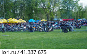 Sremska Mitrovica, Serbia, 04.29.23 Gathering or meeting of motorcyclists and bikers at a festival. People in leather clothes walk next to motorcycles. A motorcycle club. Bikerism as a subculture. Редакционное фото, фотограф Юлия Петровская / Фотобанк Лори