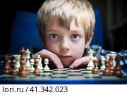 Маленький мальчик играет в шахматы. Generative AI. Стоковое AI-изображение, AI-художник Щеголева Ольга / Фотобанк Лори