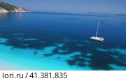Scenic panorama video from the rocky coast to a catamaran an in a bay of the greek Islands. Idyllic. Стоковое видео, видеограф Igor Tichonow / Фотобанк Лори